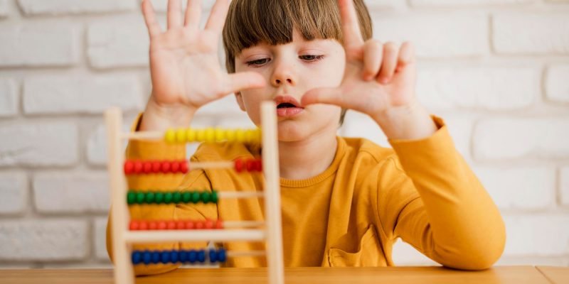 front-view-child-using-abacus-lll