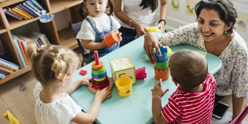 nursery-children-playing-with-teacher-in-the-classroom